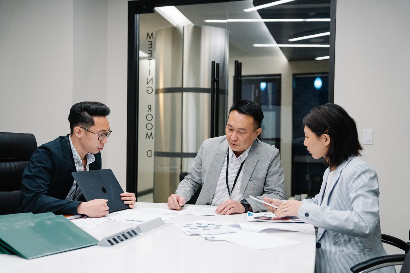 Illustrative stock photograph of professionals collaborating in a meeting room, not CMMC staff or offices