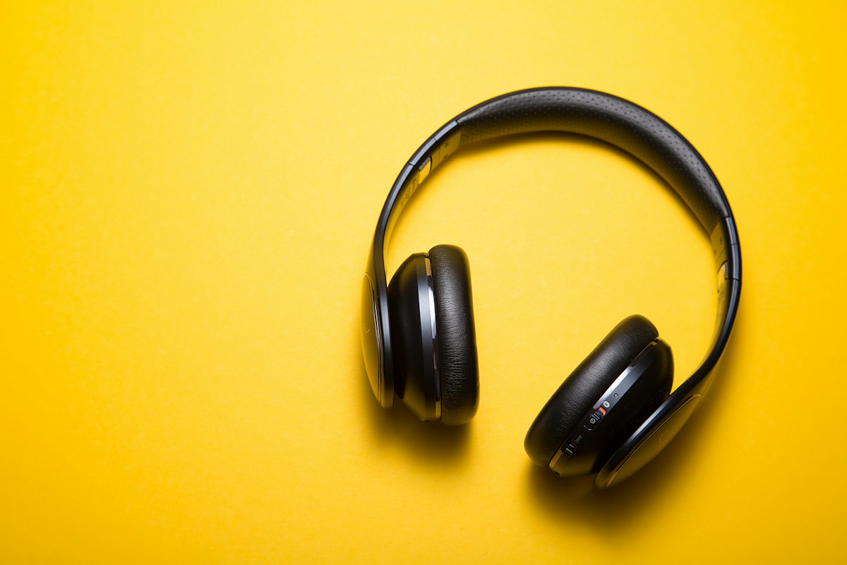 Black headphones on yellow in a concept display advertisement